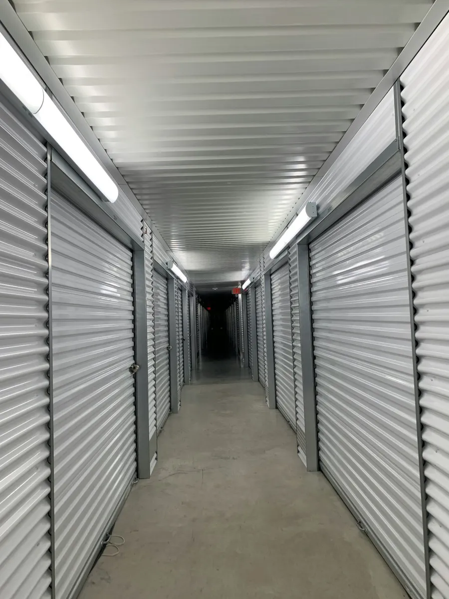 Brightly lit interior corridor lined with storage unit doors